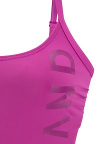 Pink swimsuit with thin straps, featuring a textured finish and bold printed text on the side. Smooth, stretchy material with a fitted design.