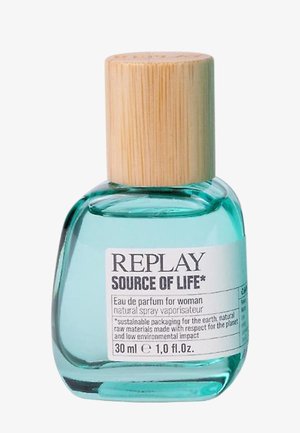 Green glass perfume bottle with a natural bamboo cap. Label includes brand name "REPLAY SOURCE OF LIFE" and product details. Volume: 30 ml.
