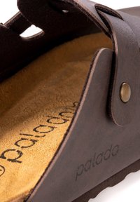 Bruine leren sandaal met een zachte, gestructureerde binnenzool. Heeft een golvende uitsnijdingen ontwerp, metalen hardware en een geprinte logo.