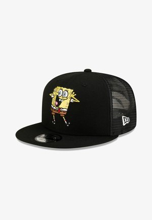 Black mesh snapback cap featuring an embroidered cheerful cartoon character with big eyes and outstretched arms on the front panel.