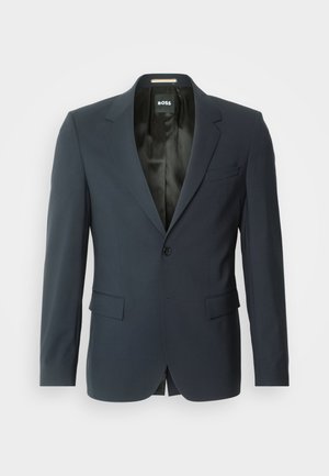 Blazer blu navy realizzato in tessuto liscio. Presenta una chiusura con un solo bottone, rever a punte e due tasche frontali. Interno foderato.