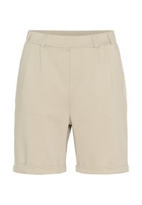 Shorts beiges sur mesure en tissu doux, avec un ourlet roulé, des plis avant et des poches latérales.