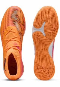 Orange atletiksko med tekstureret overdel, der har pink og sorte striber, kontrasterende hvid sål og det karakteristiske Puma-logo på siden.