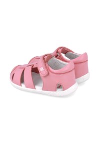 Sandalias de cuero rosa con diseño abierto, correa ajustable y suela de goma blanca. Presentan cortes y un forro suave para mayor comodidad.
