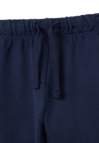 Pantalons de survêtement bleu marine avec une taille élastique et des cordons de serrage, texture douce et coupe décontractée. Pas de motifs ni d'accents visibles.