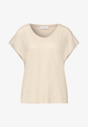 Top beige de mujer con manga corta, cuello redondo, corte holgado y etiqueta "Street One Studio" dentro del cuello.