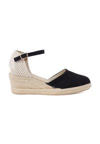 Black canvas espadrille with a woven heel, jute wedge, and adjustable black ankle strap for secure fit. Features a round toe and textured fabric.