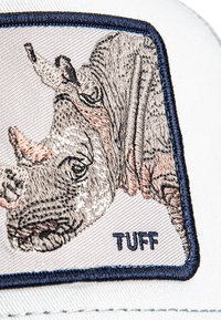 Izvezeni aplikacija s nosorogom u sivoj i bež boji na svijetloj pozadini, s natpisom "TUFF" u mornarsko plavoj boji ispod.