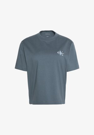 T-shirt Calvin Klein gris foncé à manches courtes avec col rond et petit logo blanc CK sur la poitrine gauche.