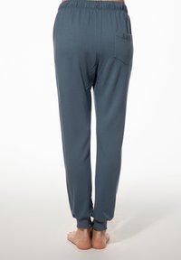 Grijze joggers van jersey met een elastische tailleband, taps toelopende boorden en één achterzak. Glad textuur en een ontspannen pasvorm.