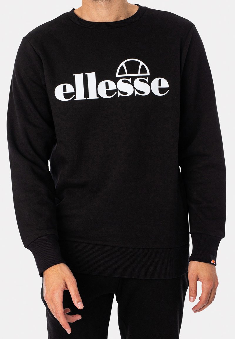 Schwarzer Pullover aus weichem Material mit einem weißen "ellesse"-Logo und einem Bogen-Design. Gerippte Bündchen und Saum. Schlichtes, minimalistisches Design.