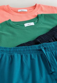 Deux t-shirts à col rond décontractés, en corail et vert, assortis à des shorts à taille élastique et cordon de serrage en bleu marine et sarcelle.