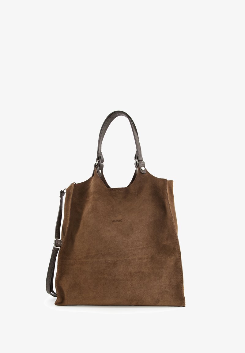 Brown suede tote bag with smooth texture, dual leather handles, and removable shoulder strap. Features minimal branding detail on front.