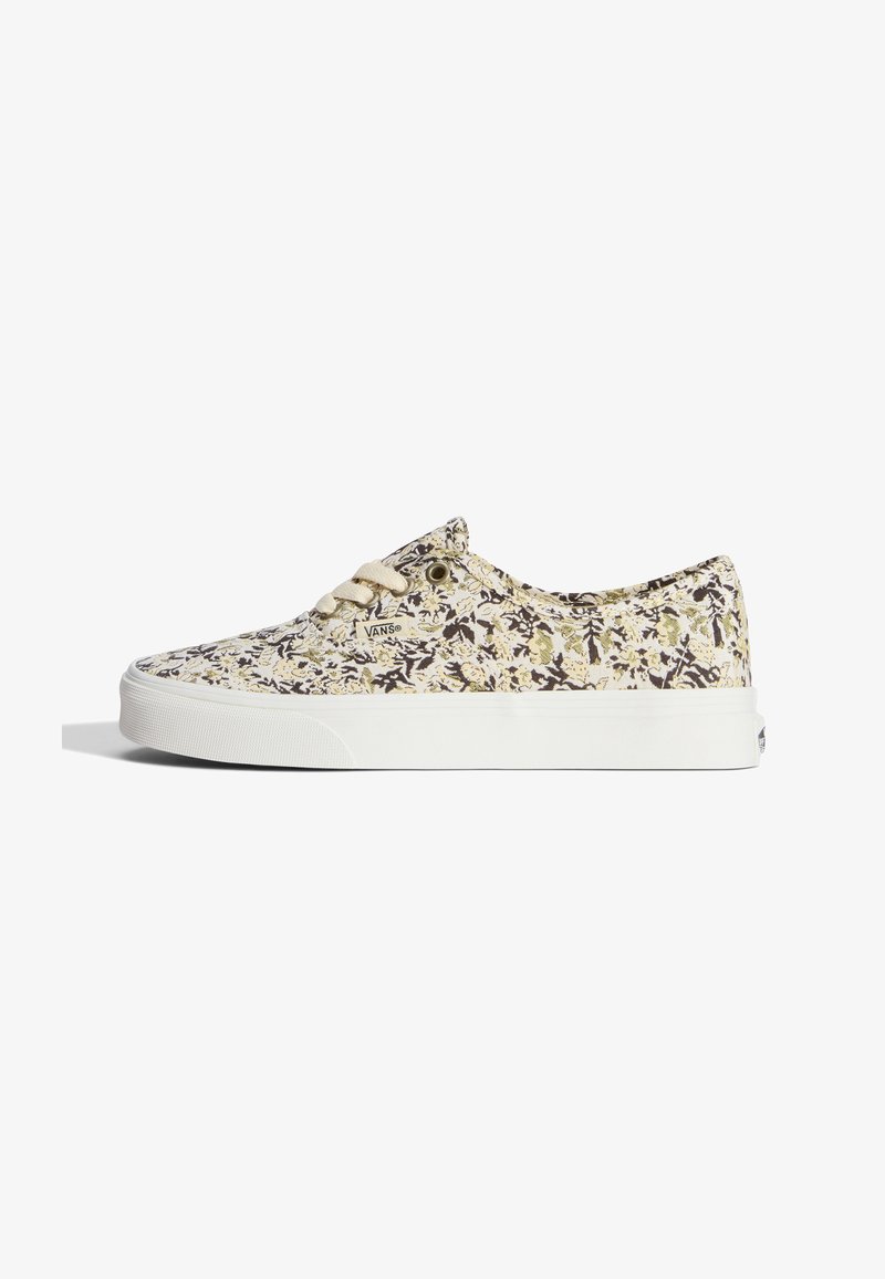 Χαμηλό παπούτσι Vans με μπεζ, μαύρο και ανοιχτό πράσινο λουλουδάτο σχέδιο και λευκή σόλα σε λευκό φόντο.