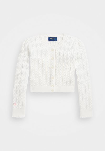 White knitted cardigan with a cable pattern, round neckline, and long sleeves. Features a button front and small embroidered detail on the sleeve.