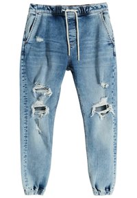 Ljusblå denim joggerbyxor med elastiska mudd, dragsko i midjan, sidofickor och flera slitna hål på framsidan av benen.