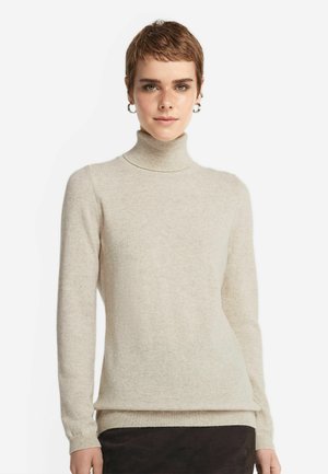 Ljus beige polokrage tröja i ett mjukt stickat tyg, med långa ärmar och ribbat avslut. Slät textur med subtila detaljer.