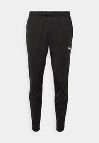 Mustat urheiluhousut, joissa on joustava vyötärö. Tasainen, kevyt materiaali, joka istuu tiukasti, ja valkoinen Puma-logo sivussa.