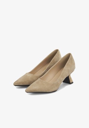 Beige suede pumps with a pointed toe and a high, angular heel. Smooth texture, simple design, and minimal embellishments.