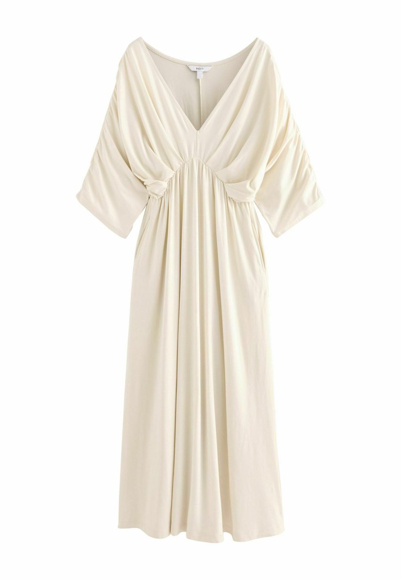 Robe couleur crème en tissu doux, avec un décolleté en V profond, des manches courtes en forme de chauve-souris, des fronces à la taille et une silhouette détendue et fluide.