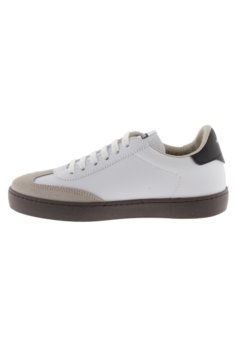 Vit sneaker med mocka tåhuvud, stuckna detaljer, platta snören, grå mockadetaljer och svart hälkappa. Gummiyttersula.