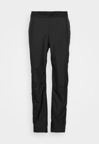 Pantalons de plein air noirs imperméables avec une texture lisse, une taille élastique et un design fuselé. Aucun élément métallique ou décoration visible.