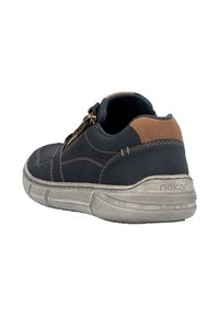 Navy fabric shoe with a brown leather accent, back zipper, and light gray sole. Features textured stitching and brand logo on the side.