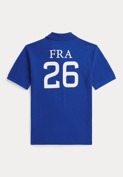 Polo azul de manga corta con texto blanco "FRA" encima del número grande "26" en la parte trasera sobre un fondo blanco liso.