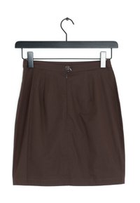 Brun veckad kjol med knäppning, hängande från en svart klämma. Tyget verkar slätt och lätt med en ren fåll.