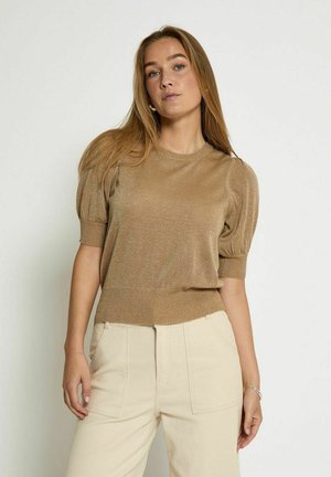 Gold knit pullover with short puff sleeves and a ribbed hem. Worn with beige high-waisted trousers, featuring a smooth texture and minimalist design.