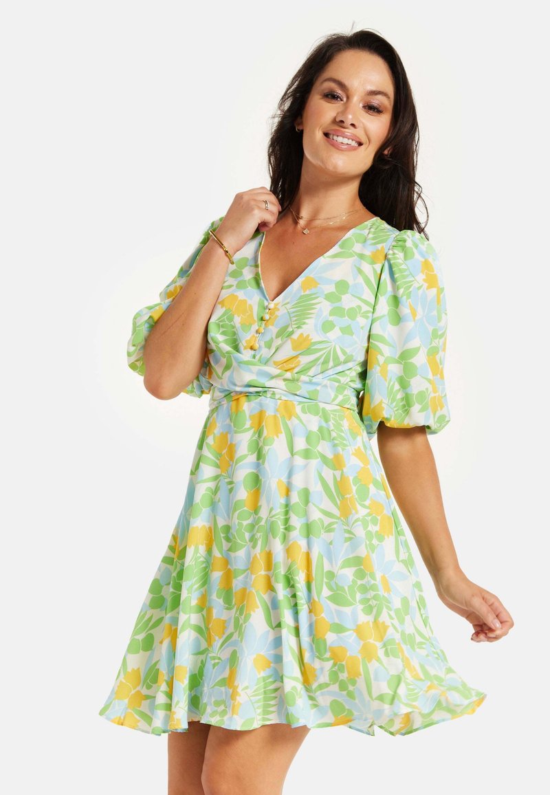 Floral dress featuring a v-neck, puff sleeves, and a fitted waist. Colors include light blue, yellow, and green botanical patterns.