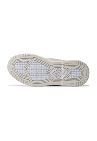 White sneaker sole with textured grip pattern, featuring a hexagonal design. DC logo in the center and small traction lines along the edges.