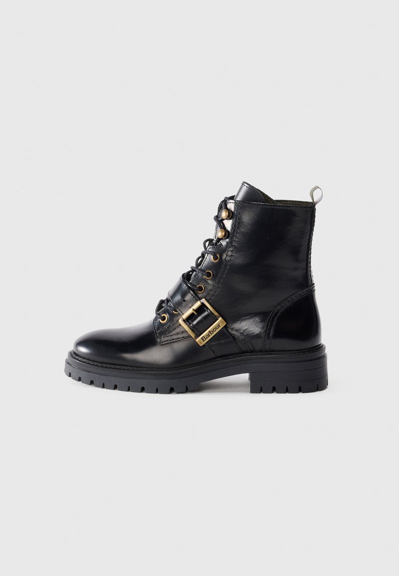 Black leather ankle boot with gold hardware, lace-up front, side buckle detail, and textured sole. Smooth finish with a rounded toe.