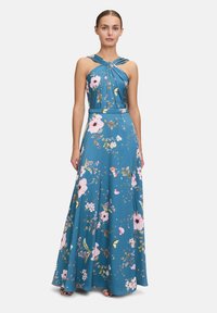 Blaues Maxikleid aus blumigem Stoff, mit gefaltetem Oberteil, Halterneck und schwingendem Rock. Akzentuiert mit rosa und grünen Blumenmustern.