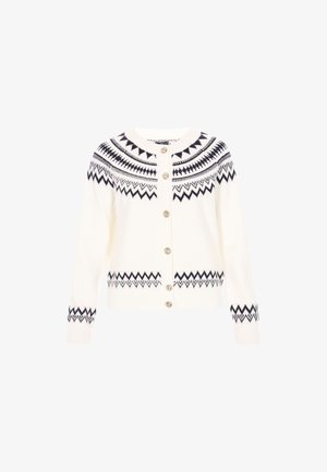 Valge põimitud kardigan, millel on tumesinine geomeetriline muster, ümmargune kaelus, ees nupud ja soonikkoes mansetid. Pehme tekstuur ja lühendatud lõige.