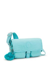 Turquoise crossbody bag made of durable fabric, featuring a flap closure, adjustable strap, and a plush monkey keychain accent.