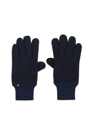 Un paio di guanti di maglia blu navy con polsini a coste, distesi piatti con i palmi rivolti verso il basso su uno sfondo bianco.