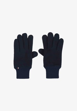 Paire de gants en tricot bleu marine avec des poignets côtelés, posés à plat avec les paumes vers le bas sur un fond blanc.