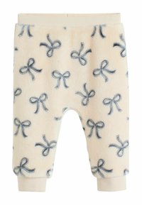 Fleece-Hosen in zartem Creme mit Marineblauen Schleifenmustern, ausgestattet mit einer weichen Textur und einem elastischen Bund mit engen Bündchen.