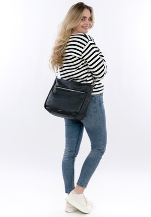 Black leather shoulder bag with a front zip pocket, silver hardware, and a heart charm. Smooth texture and rectangular shape.