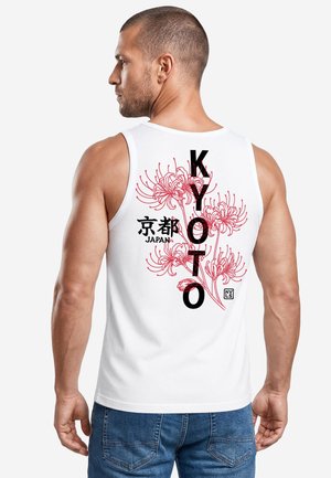 Man wearing white sleeveless shirt with red floral design and black text reading "KYOTO" and Japanese characters above "JAPAN" on the back.