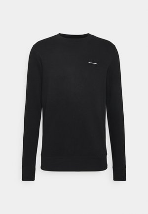 Felpa nera in misto cotone, con scollatura a girocollo, maniche lunghe e una piccola etichetta logata sul lato sinistro del petto. Texture liscia.