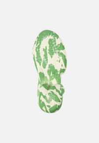 Green and white patterned sandal with a textured footbed, featuring a rounded toe and a smooth sole, designed for comfort and grip.