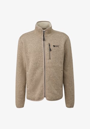 Bežový flísový kabát s farebnými bodkami, plným predným zipsom, vreckom na zips na hrudi, vysokým golierom a nášivkou "Elevated Casual est. 1969" na hrudi.