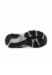 Black and gray athletic shoe sole with deep tread, durable rubber material, and textured patterns for traction; logo prominently visible.