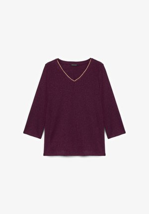 V-Ausschnitt, dreiviertelärmliges Oberteil aus tiefviolettem Stoff mit subtiler Schimmeroptik, das einen goldenen Rand entlang des Ausschnitts hat.