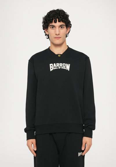 Sudadera negra de manga larga, con cuello redondo y un logo blanco que dice "BARROW HALL OF FAME". La tela parece suave y texturizada.