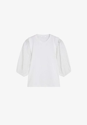 Weiße Bluse mit rundem Ausschnitt und voluminösen dreiviertel Ärmeln aus Lochspitze mit wellenförmigen Mustern.