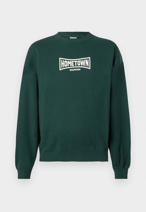 Sweatshirt de pescoço redondo verde escuro com o texto "CAMPEÃO DA CIDADE" impresso em branco no peito, com punhos e barra canelados.
