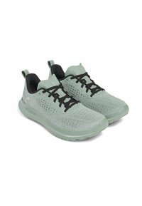 Light green athletic shoes made of breathable fabric, featuring black laces, a padded collar, and a thick sole with a textured finish.
